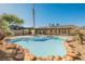 A refreshing backyard pool with rock features provides an ideal escape in the desert setting at 4016 Tyler William Ln, Las Vegas, NV 89130