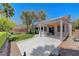 Covered back patio with concrete and lawn offers a relaxing outdoor space at 4197 Bottiglia Ave, Las Vegas, NV 89141