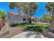 A lush backyard featuring a well-maintained lawn, covered patio, and privacy landscaping at 4197 Bottiglia Ave, Las Vegas, NV 89141