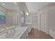 Bright bathroom with dual sinks, walk-in shower, tub, and tile floors at 4197 Bottiglia Ave, Las Vegas, NV 89141