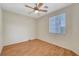 Comfortable bedroom with a ceiling fan and bright window with wood laminate flooring at 4197 Bottiglia Ave, Las Vegas, NV 89141