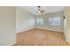 Spacious bedroom with laminate floors, ceiling fan, and natural light from two windows at 4197 Bottiglia Ave, Las Vegas, NV 89141