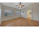 A bright bedroom featuring a ceiling fan and natural light with an ensuite bath at 4197 Bottiglia Ave, Las Vegas, NV 89141