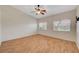 Bedroom featuring wood look floors, ceiling fan, and natural light from two windows at 4197 Bottiglia Ave, Las Vegas, NV 89141
