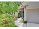 Inviting home front featuring mature tree and landscaped walkway to front door at 4197 Bottiglia Ave, Las Vegas, NV 89141