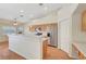 Bright kitchen with stainless steel appliances, wood cabinets, and laminate wood flooring at 4197 Bottiglia Ave, Las Vegas, NV 89141
