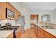 Kitchen features stainless steel appliances, ample cabinetry, and laminate wood floors at 4197 Bottiglia Ave, Las Vegas, NV 89141