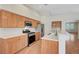 Kitchen features stainless steel appliances, ample cabinetry, and laminate wood floors at 4197 Bottiglia Ave, Las Vegas, NV 89141