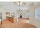 Open-concept living room featuring a fireplace and kitchen bar with wood floors at 4197 Bottiglia Ave, Las Vegas, NV 89141