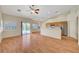 Open-concept living area with wood floors, kitchen access, and sliding doors to the backyard at 4197 Bottiglia Ave, Las Vegas, NV 89141