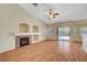 Inviting living room with a cozy fireplace, wood floors, and sliding glass doors at 4197 Bottiglia Ave, Las Vegas, NV 89141