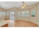 Bright and airy living area with sliding glass doors, windows, and wood floors at 4197 Bottiglia Ave, Las Vegas, NV 89141