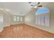 Bright and airy living room with wood floors, high ceilings, and large windows at 4197 Bottiglia Ave, Las Vegas, NV 89141