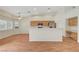 Bright, open-concept space connecting the kitchen and living area with wood floors at 4197 Bottiglia Ave, Las Vegas, NV 89141