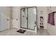 Modern bathroom featuring tiled shower with glass door, and tile flooring at 4519 Sapphire Moon Ave, North Las Vegas, NV 89084