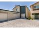 View of the garages with neutral paint and large paved driveway in front of the property at 4519 Sapphire Moon Ave, North Las Vegas, NV 89084