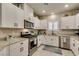 Modern kitchen featuring stainless steel appliances, granite counters and white cabinets at 4519 Sapphire Moon Ave, North Las Vegas, NV 89084