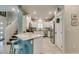Modern kitchen with white cabinets, granite countertops, stainless steel appliances, and a breakfast bar at 4519 Sapphire Moon Ave, North Las Vegas, NV 89084