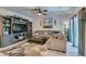 A beautifully decorated living room with lots of light features a large sectional and ceiling fan at 4519 Sapphire Moon Ave, North Las Vegas, NV 89084