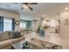 Open-concept view of the living room, dining room, kitchen, and staircase in a naturally lit space at 4519 Sapphire Moon Ave, North Las Vegas, NV 89084