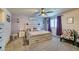 Spacious main bedroom with a ceiling fan, carpet flooring, and ample natural light at 4519 Sapphire Moon Ave, North Las Vegas, NV 89084