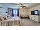 Comfortable main bedroom with ceiling fan, carpet, and neutral tones at 4519 Sapphire Moon Ave, North Las Vegas, NV 89084