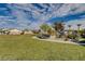 Community park offering grassy lawns and a walking path lined with benches and landscaping at 4519 Sapphire Moon Ave, North Las Vegas, NV 89084