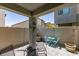 Cozy patio space with modern gray stone flooring, wood fence, and blue patio set at 4519 Sapphire Moon Ave, North Las Vegas, NV 89084