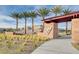 Entrance to Valley Vista community, with manicured desert landscaping, stone monument, and palm tree lined street at 4519 Sapphire Moon Ave, North Las Vegas, NV 89084
