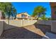 Private backyard features gravel landscaping, fence, and mature trees at 4779 Straight Flush Dr # 103, Las Vegas, NV 89122