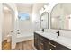 Modern bathroom with double sinks, sleek hardware, a walk-in shower, and a well-lit vanity at 4779 Straight Flush Dr # 103, Las Vegas, NV 89122