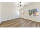 Bright bedroom with wood-look floors, modern ceiling light, and large windows at 4779 Straight Flush Dr # 103, Las Vegas, NV 89122