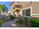 Inviting front entrance with a well-maintained walkway, manicured bushes, and a charming covered porch at 4779 Straight Flush Dr # 103, Las Vegas, NV 89122