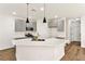 Stylish kitchen featuring stainless steel appliances, a breakfast bar, pendant lighting and grey cabinets at 4779 Straight Flush Dr # 103, Las Vegas, NV 89122