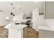 Modern kitchen with an island, stainless steel appliances, gray cabinets, and a gold faucet at 4779 Straight Flush Dr # 103, Las Vegas, NV 89122