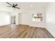 Bright living room with an open floor plan, sliding glass door, and wood-look floors throughout the main floor at 4779 Straight Flush Dr # 103, Las Vegas, NV 89122