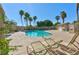 Relaxing community pool surrounded by palm trees and lounge chairs for residents' enjoyment at 4779 Straight Flush Dr # 103, Las Vegas, NV 89122