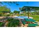Community splash pad with rainbow water feature, picnic tables, and lush landscaping at 4779 Straight Flush Dr # 103, Las Vegas, NV 89122