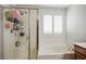 Bright bathroom features a separate shower and soaking tub beneath shuttered window at 4786 Castel Martini Ct, Las Vegas, NV 89147