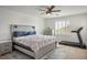 Bright bedroom with a ceiling fan, king bed and a treadmill for convenient home fitness at 4786 Castel Martini Ct, Las Vegas, NV 89147