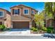 A residence showing a two-car garage and tasteful front yard landscaping at 4786 Castel Martini Ct, Las Vegas, NV 89147