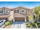 Two-story home boasts a two-car garage, desert landscaping, and a covered entryway at 4786 Castel Martini Ct, Las Vegas, NV 89147