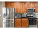 Kitchen boasts stainless steel appliances, granite countertops, and rich wood cabinetry at 4786 Castel Martini Ct, Las Vegas, NV 89147