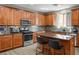 Modern kitchen with granite countertops, stainless steel appliances, and a cozy breakfast bar at 4786 Castel Martini Ct, Las Vegas, NV 89147