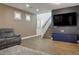 Stylish living space with wood floors, modern blue cabinets, and a large flat-screen TV at 4786 Castel Martini Ct, Las Vegas, NV 89147