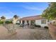 Spacious backyard with a covered patio, seating area, and well-maintained landscaping at 5020 Linkside Dr, Las Vegas, NV 89130