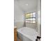 Relaxing bathroom showcasing a large soaking tub with tile surround and natural light at 5020 Linkside Dr, Las Vegas, NV 89130