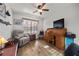 Cozy bedroom features a ceiling fan, wood floors, and a comfortable recliner at 5020 Linkside Dr, Las Vegas, NV 89130
