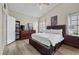 Comfortable bedroom with wood floor, ceiling fan, ample space and storage at 5020 Linkside Dr, Las Vegas, NV 89130