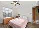 Bright bedroom featuring a window, wooden floor, ceiling fan, and cozy bed at 5020 Linkside Dr, Las Vegas, NV 89130